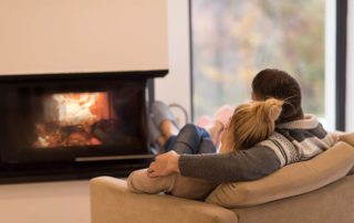 couple sitting in front of fireplace
