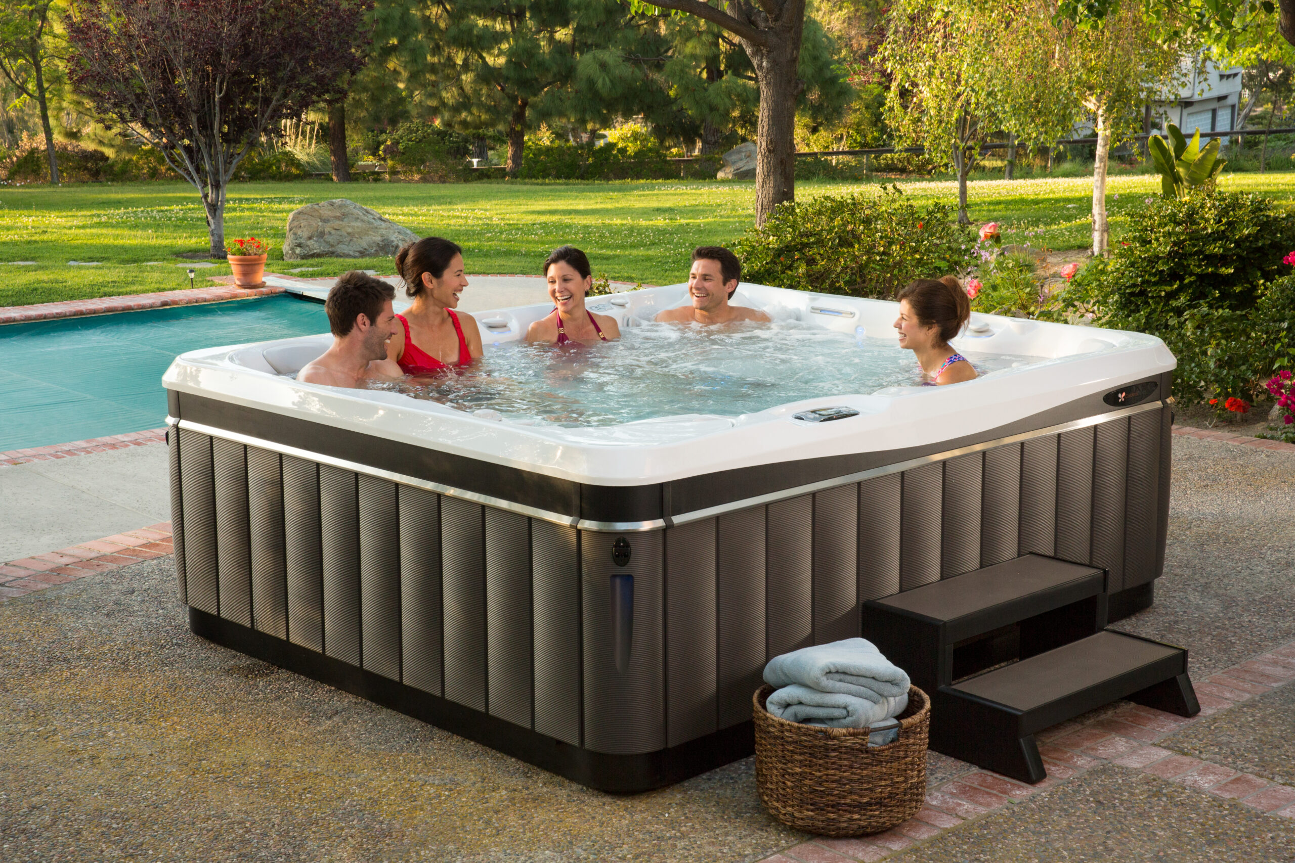 People sitting in hot water tub.